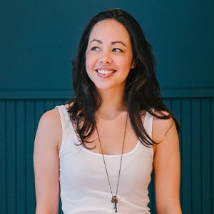 woman in front of green wall